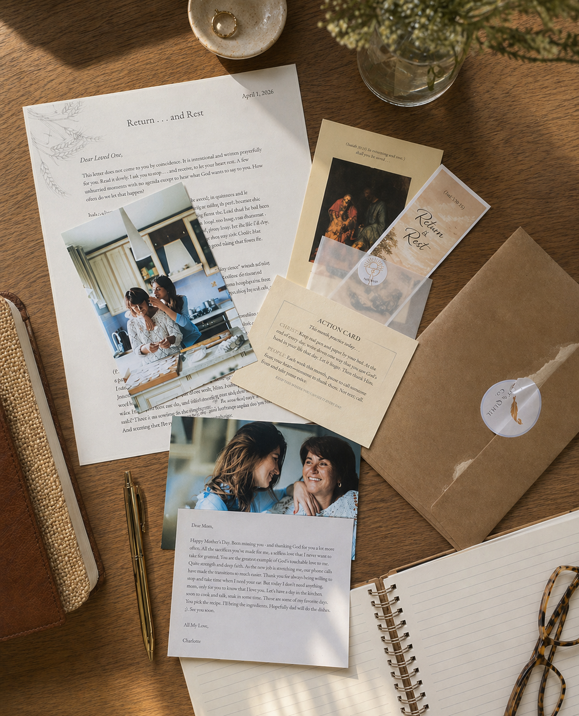 Collection of printed photos and documents on a wooden surface with a pen and notebook.